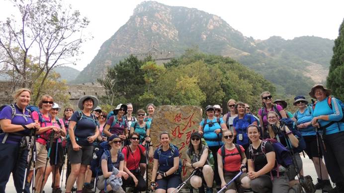 Group of Girlguiding China trekkers standing in front of a peak