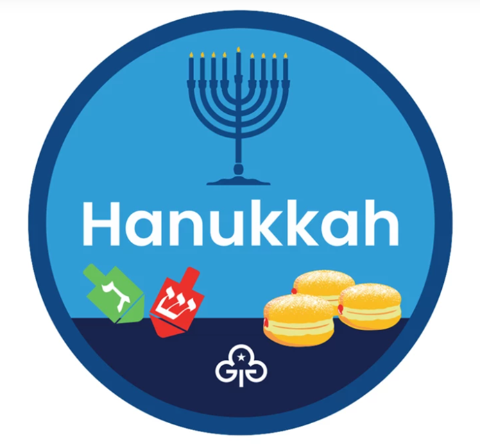 An image of our new Hanukkah badge, featuring a Hanukkah menorah, dreidels and sufganiyot